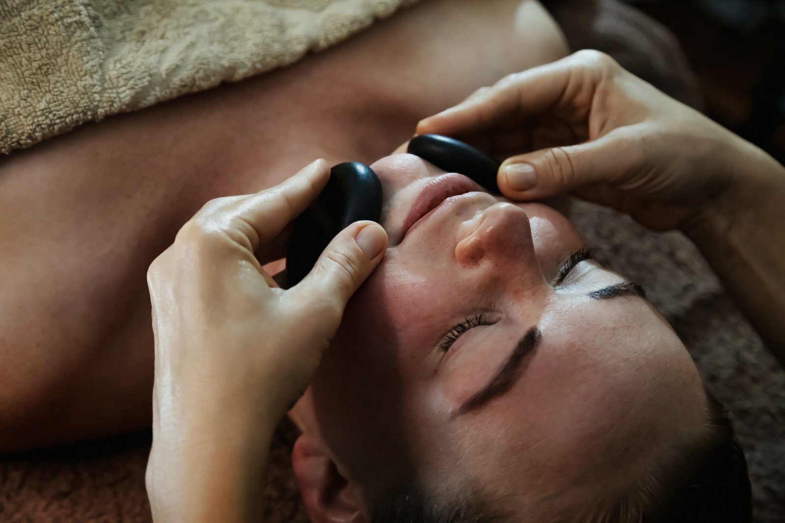 woman receiving a relaxing facial with hot stones 2026 01 08 08 24 05 utc scaled